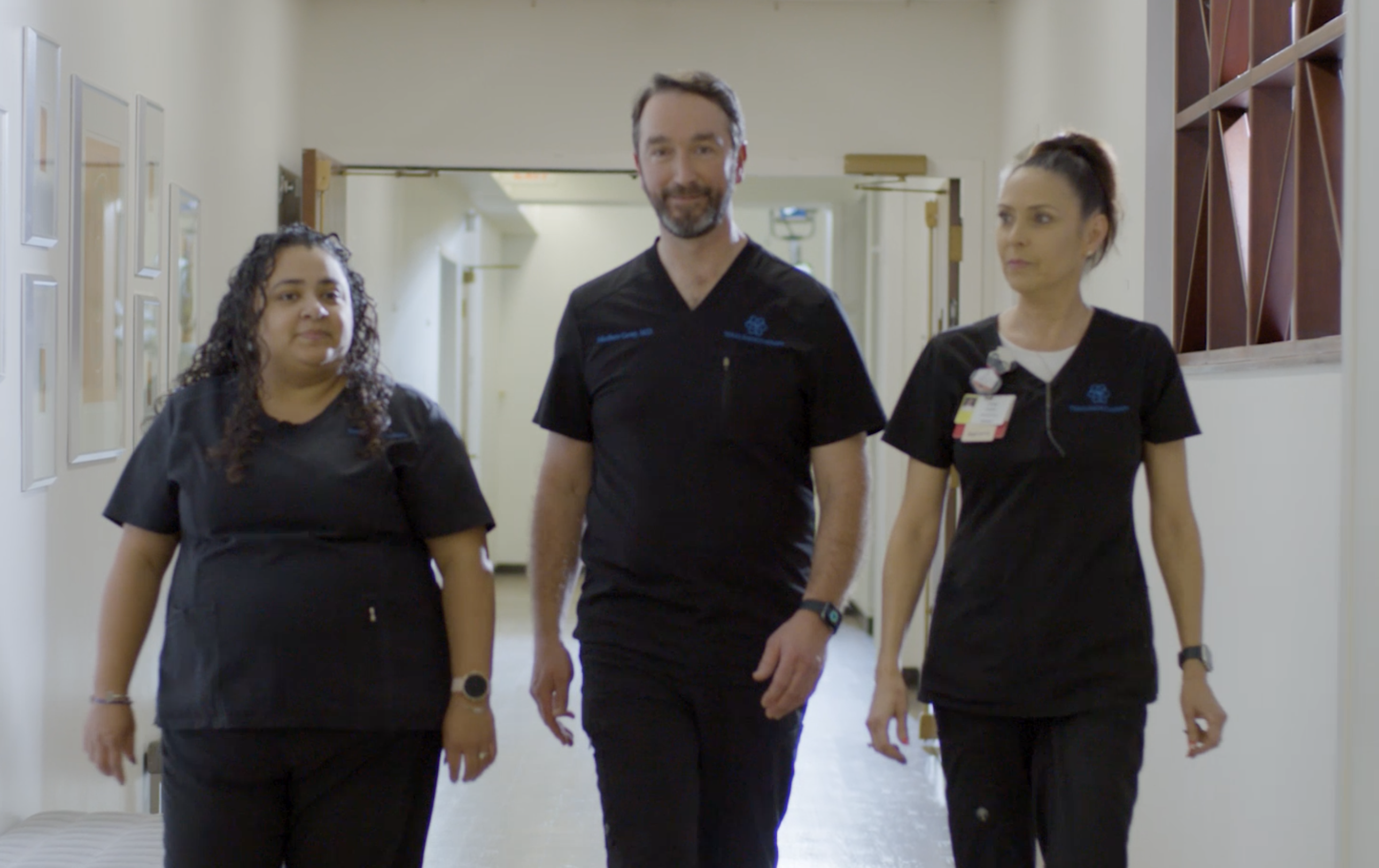 Dr. Cavey and his team walking down a hallway